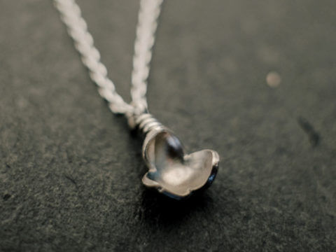 pendentif en argent composé d'une petite fleur à trois pétales, monté sur chaîne