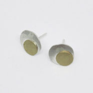 boucles d'oreilles puces composées de deux pastilles martelées en argent et laiton, montées sur clous.